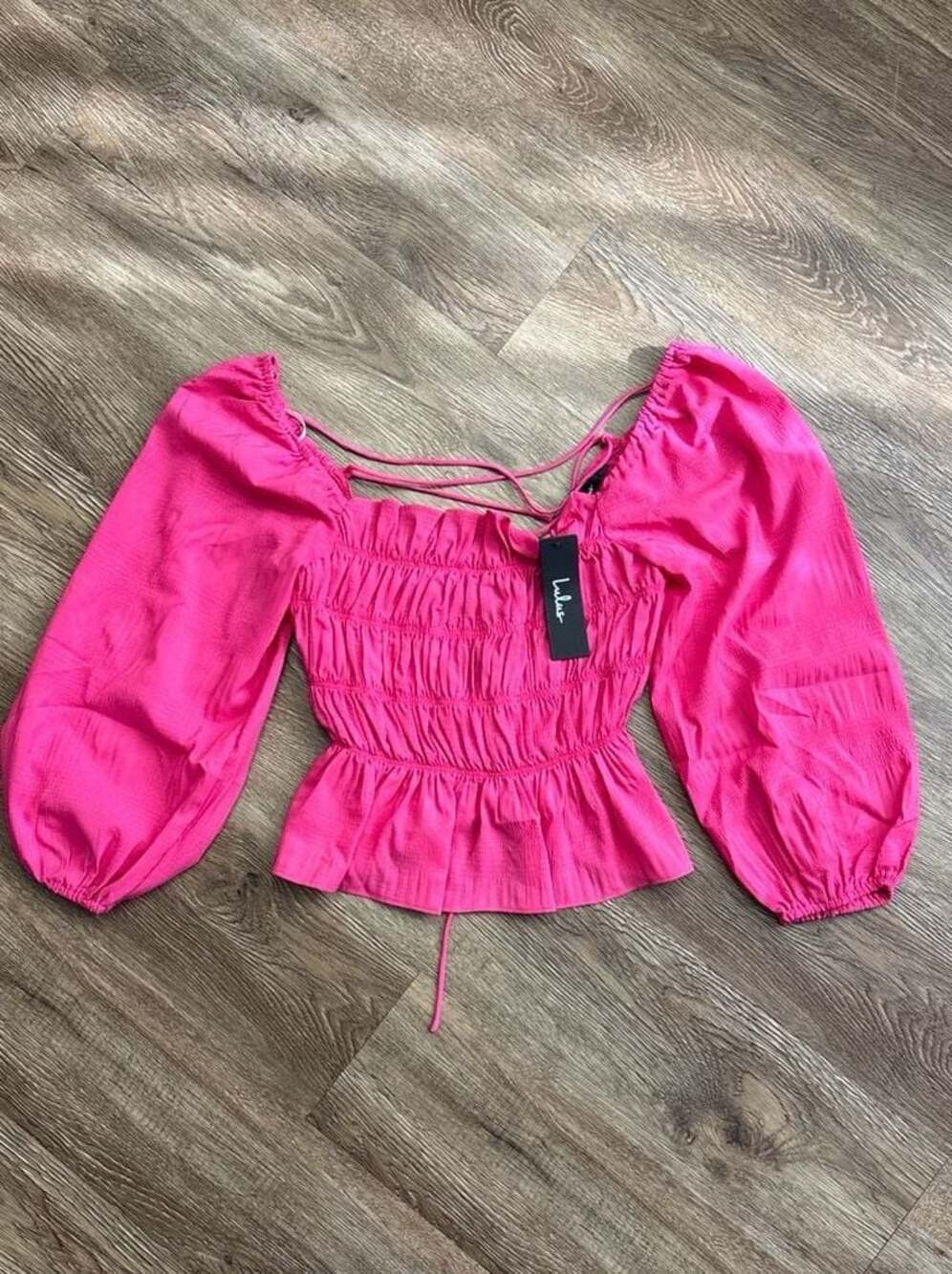 Lulus Flirty Reveal Hot Pink Smocked Long Sleeve Lace-Up Peplum Top